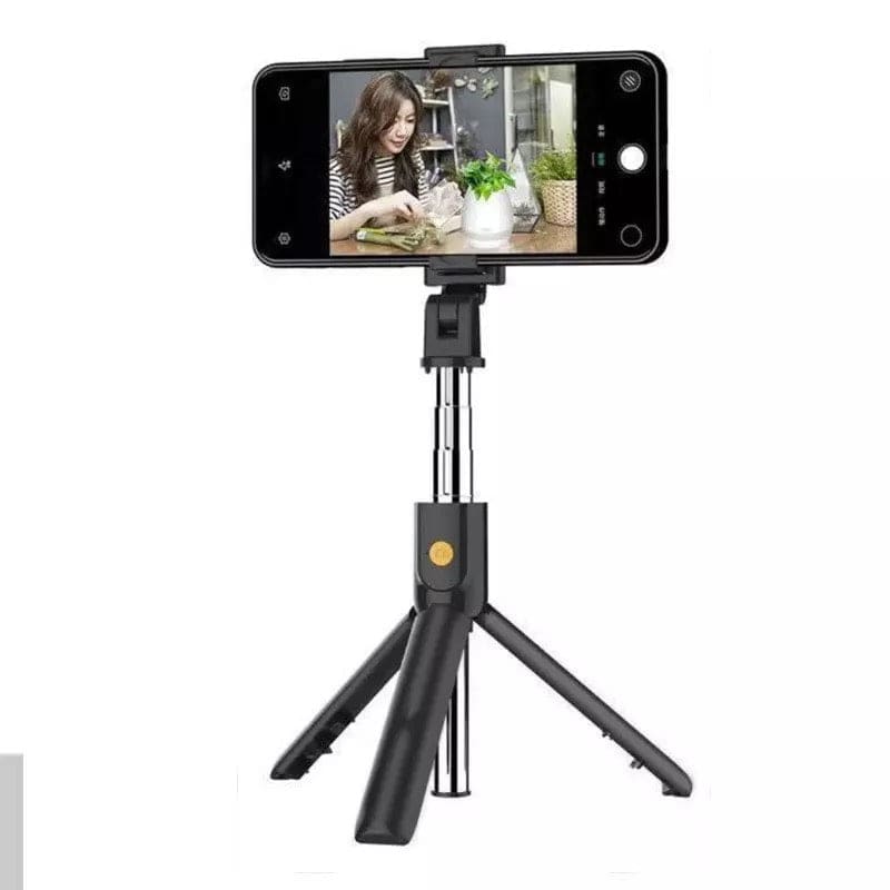 9eight5 selfie stick with remote and stand for phones and tablets, showing the extendable stick and remote control in hand.