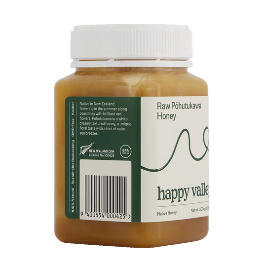 Side view of raw Pohutukawa native honey in a jar from Happy Valley Honey, showcasing its golden color and natural texture.