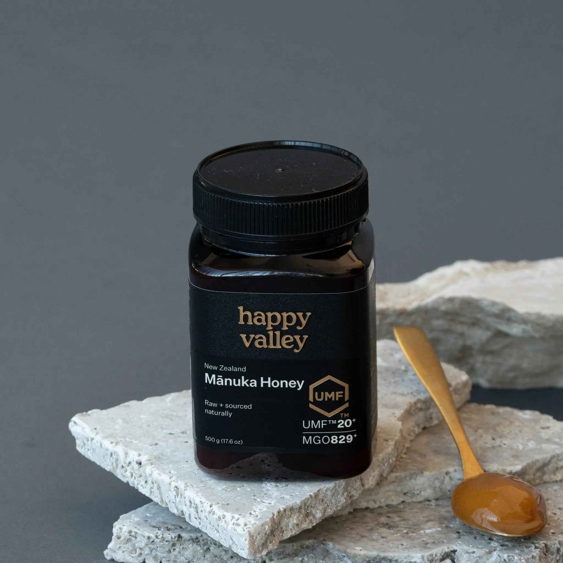Jar of Happy Valley Honey Mānuka Honey UMF® 20+ with golden honey visible in a clear glass jar.