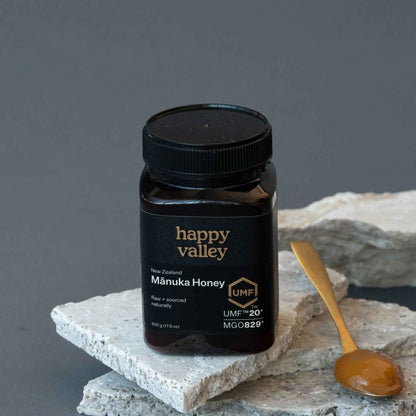 Jar of Happy Valley Honey Mānuka Honey UMF® 20+ with golden honey visible in a clear glass jar.
