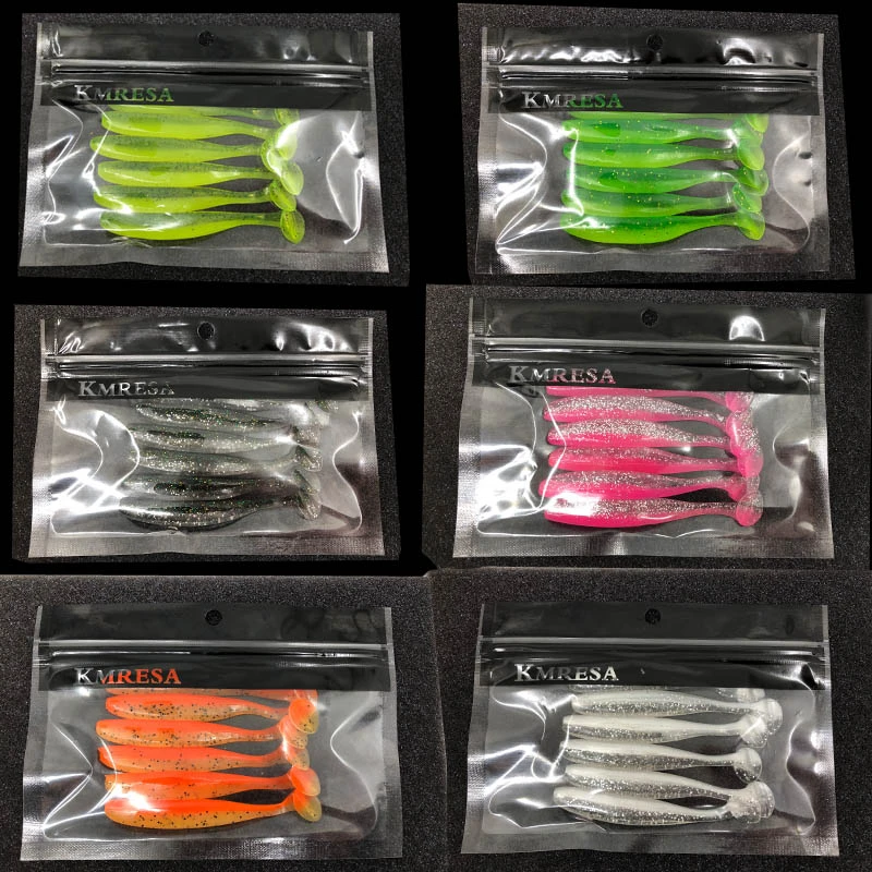 Assorted soft fishing lures with hooks in a clear tackle box, ideal for freshwater or saltwater fishing.