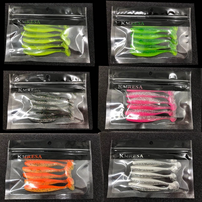 Assorted soft fishing lures with hooks in a clear tackle box, ideal for freshwater or saltwater fishing.