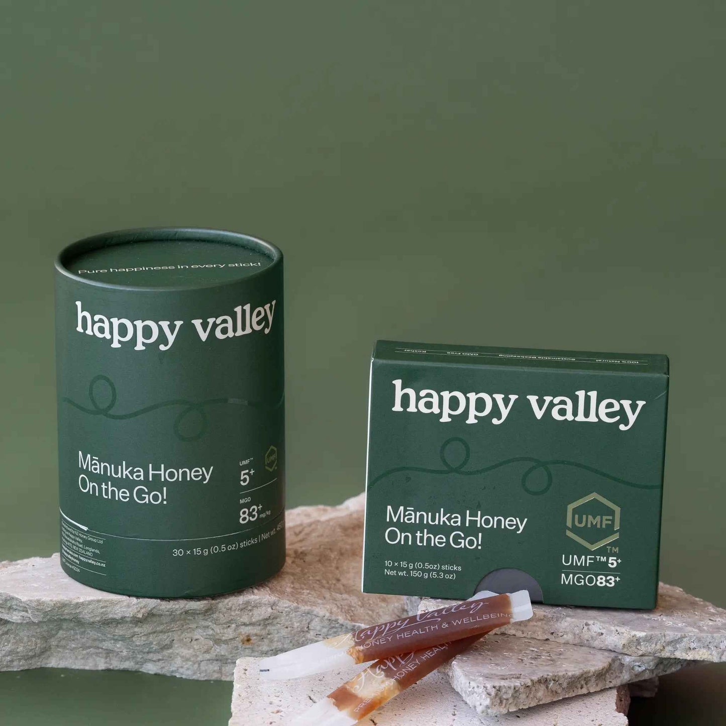 Two on-the-go UMF 5+ Manuka honey sticks from Happy Valley Honey, featuring easy-to-carry packets of natural Manuka honey.
