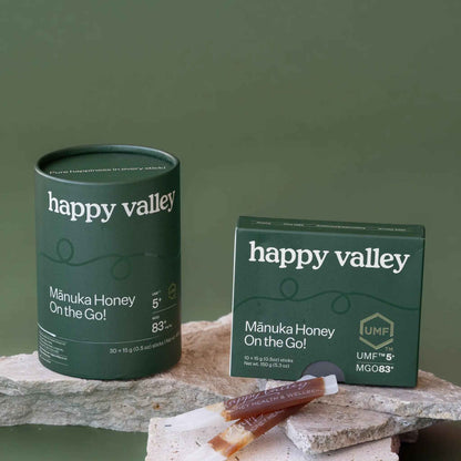 Two on-the-go UMF 5+ Manuka honey sticks from Happy Valley Honey, featuring easy-to-carry packets of natural Manuka honey.