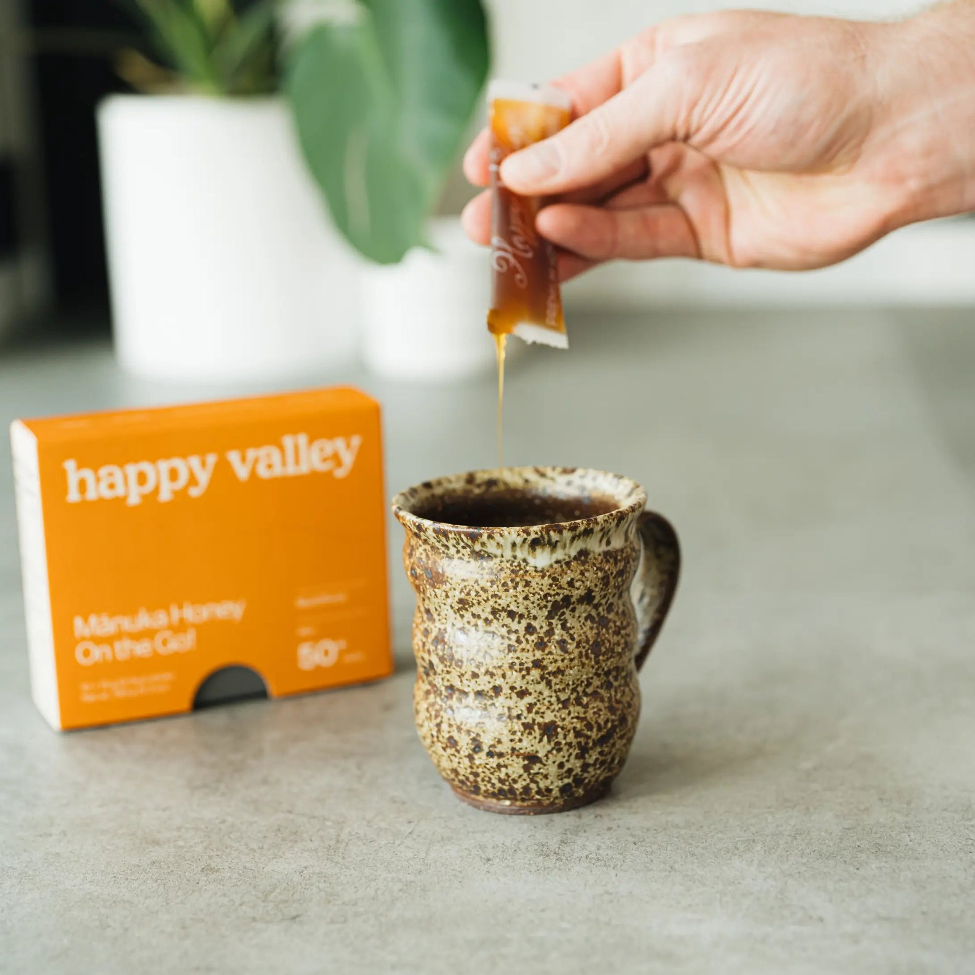 Three Happy Valley Honey Manuka honey packets with on-the-go sticks, featuring multifloral Manuka MGO 50+ honey.