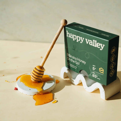 Three Happy Valley Honey Manuka honey packets with UMF 5+ on the packaging, designed for on-the-go use.