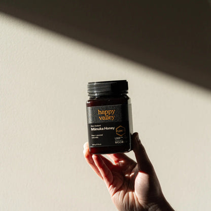 Jar of Happy Valley Honey Mānuka Honey UMF® 20+ with golden honey inside, showcasing premium manuka honey quality.