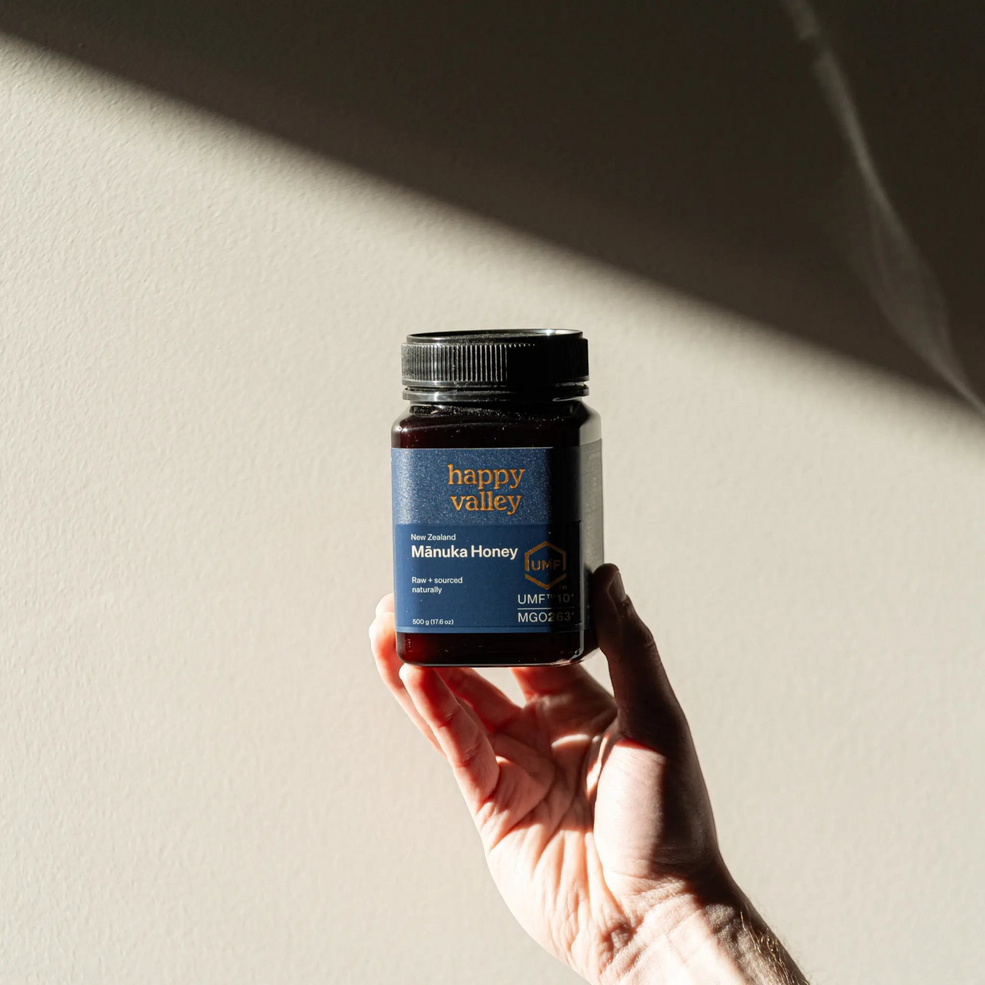 Jar of UMF® 10+ Manuka Honey from Happy Valley Honey with golden, thick honey inside the jar.