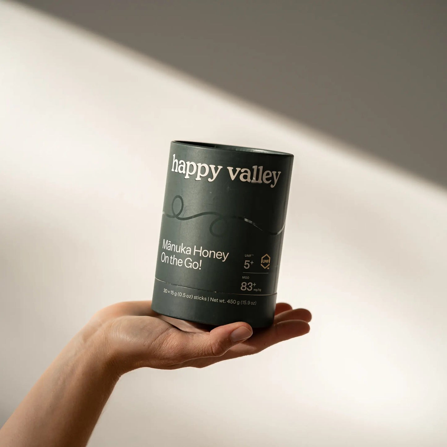 Five on-the-go UMF 5+ Manuka honey sticks from Happy Valley Honey, ready for convenient use.
