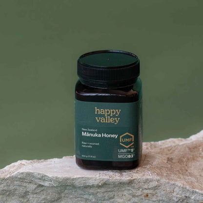 Jar of Happy Valley Honey UMF 5+ Manuka Honey with golden color and label showing UMF 5+ on a white background