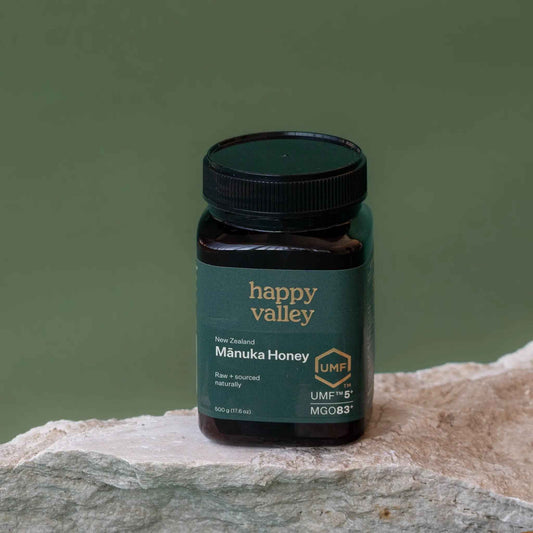Jar of Happy Valley Honey UMF 5+ Manuka Honey with golden color and label showing UMF 5+ on a white background