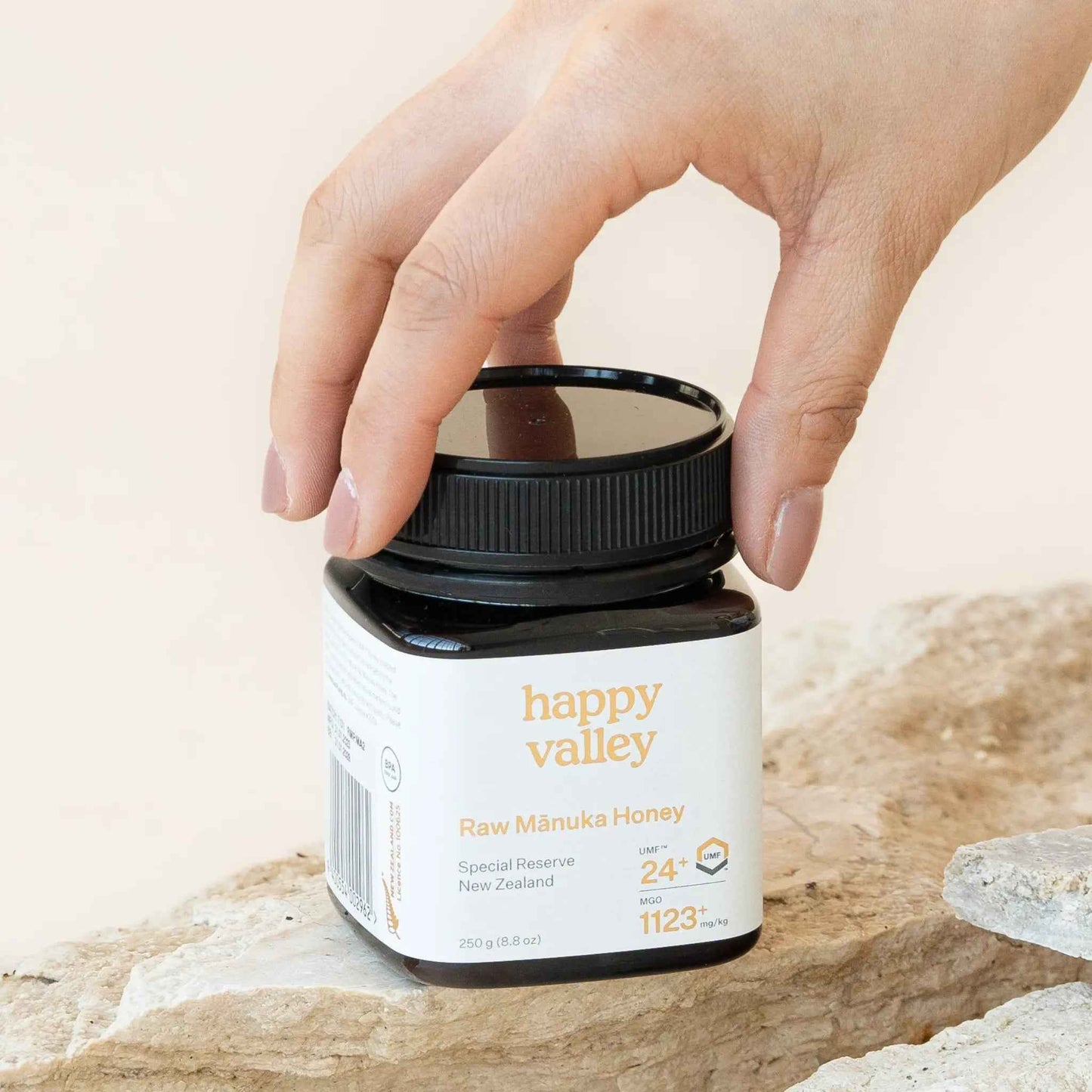 Jar of Happy Valley Honey Mānuka Honey UMF® 24+ with golden color and label visible, showcasing premium Manuka honey.