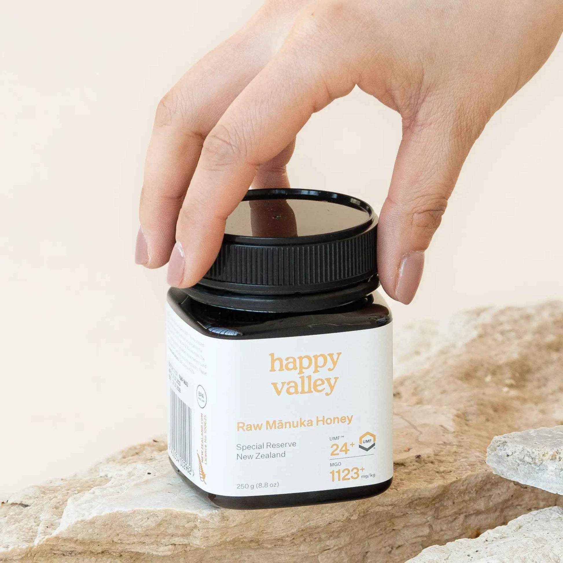 Jar of Happy Valley Honey Mānuka Honey UMF® 24+ with golden color and label visible, showcasing premium Manuka honey.