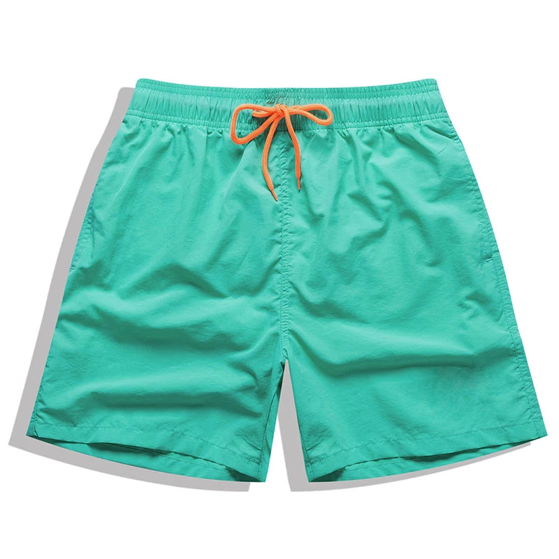Men's beach boardshorts by ShopHub NZ featuring surf-style design, quick-dry fabric, and vibrant colors for swimming and beach sports.