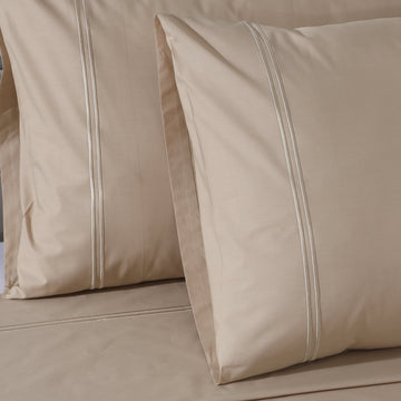 Organic cotton coloured sheet set in humus tone with 250 thread count from Whites of London NZ, featuring neatly folded bedding.