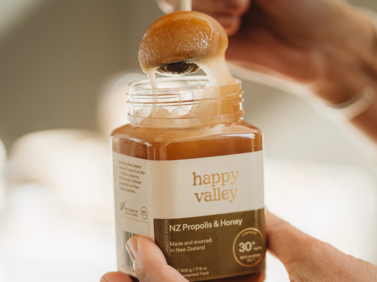 Close-up of Happy Valley Honey NZ Propolis and honey jar, showcasing the natural propolis and honey product container.