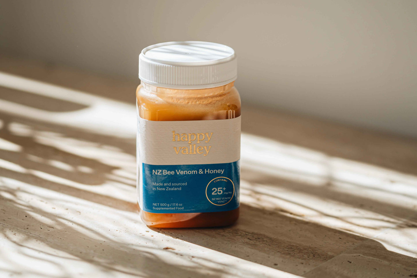 Jar of Happy Valley Honey bee venom with honey, showcasing a natural bee venom and honey product from Happy Valley Honey.