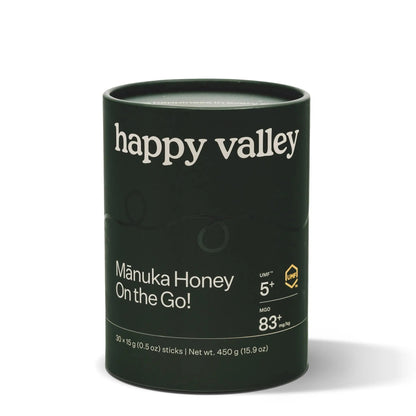Jar of Happy Valley Honey UMF 5+ Mānuka Honey with golden color and honeycomb texture visible.