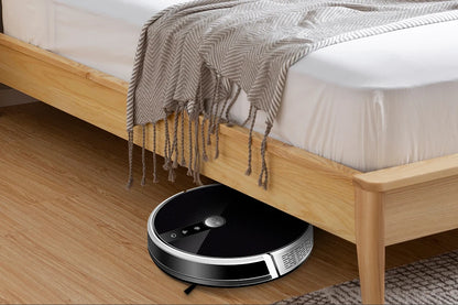 LIECTROUX C30B robot vacuum cleaner on a hardwood floor with its charging dock, showcasing compact design and cleaning features.