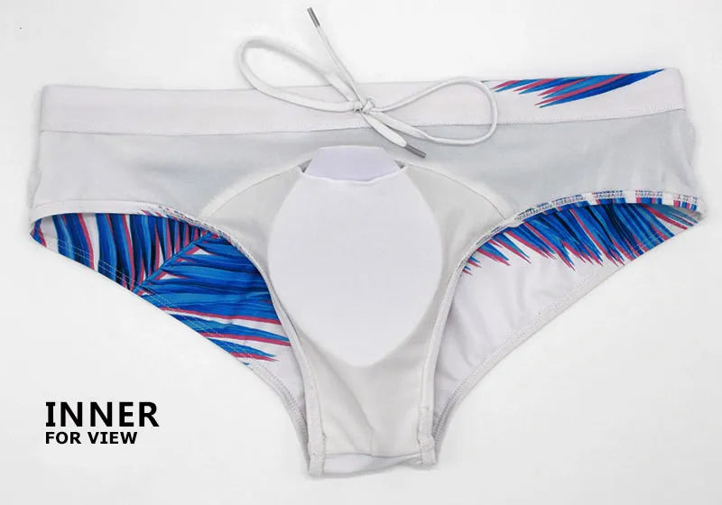 Men's low waist swim briefs with bold print design, designed for comfort and style in vibrant swimwear by ShopHub NZ.