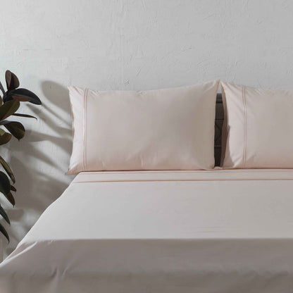Organic cotton coloured sheet set in peach mist with 250 thread count, featuring soft, smooth bed linens from Whites of London NZ.