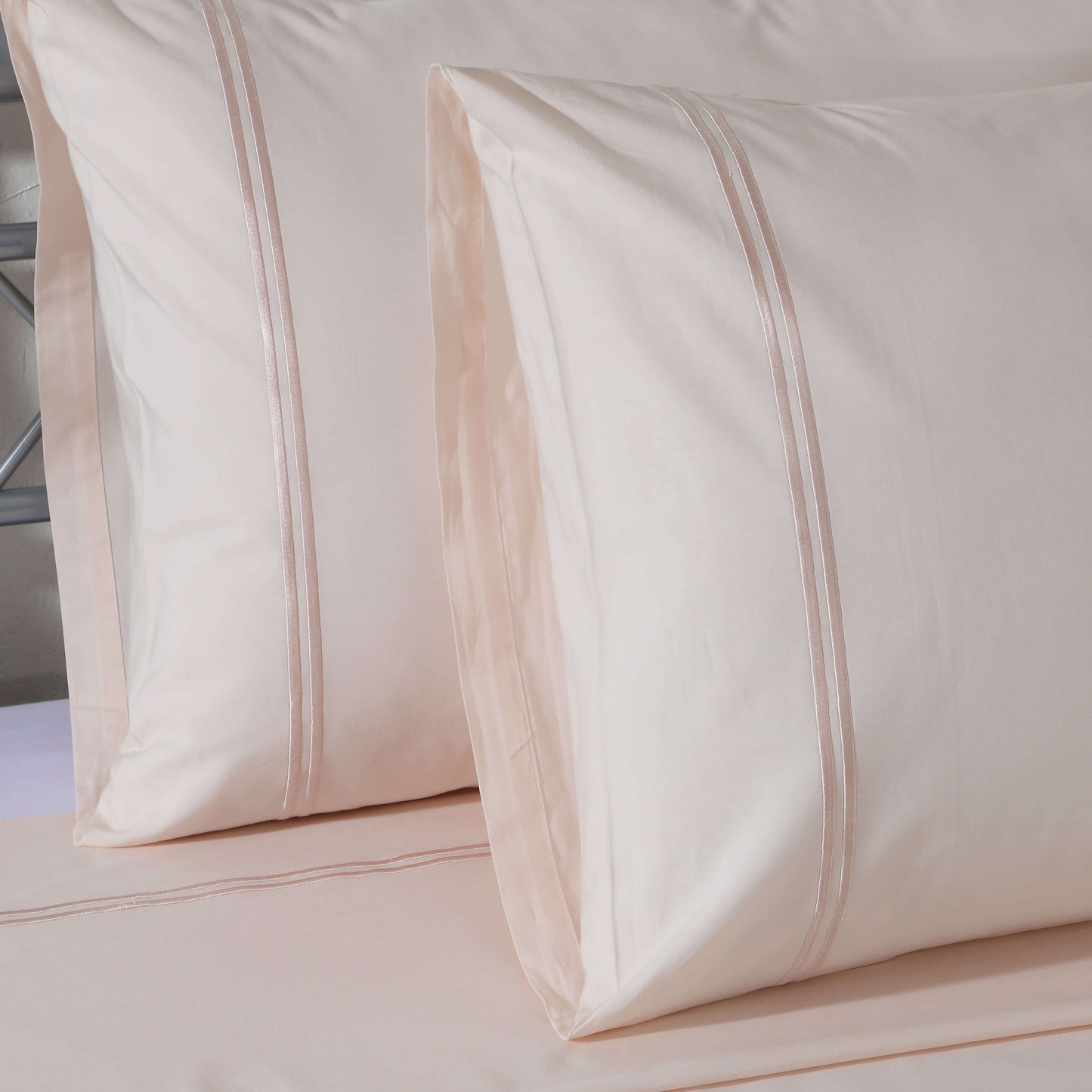 Organic cotton coloured sheet set in peach mist with 250 thread count from Whites of London NZ, showing the soft, pastel bedding.