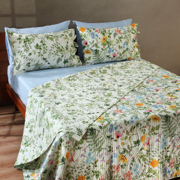 Whites of London NZ reversible garden walk percale quilt set with floral and geometric patterns, neatly arranged on a bed.
