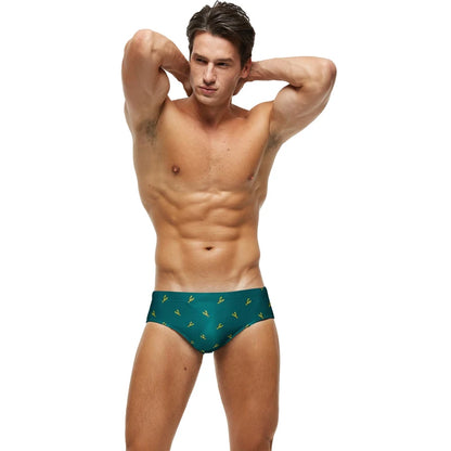 Men's low waist swim briefs with sexy print design, stylish men's swimwear by ShopHub NZ, shown in black and vibrant patterns.