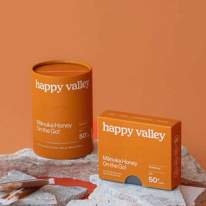 Unopened honey packets of Happy Valley Honey Manuka Honey sticks with natural floral packaging and MGO 50+ label.