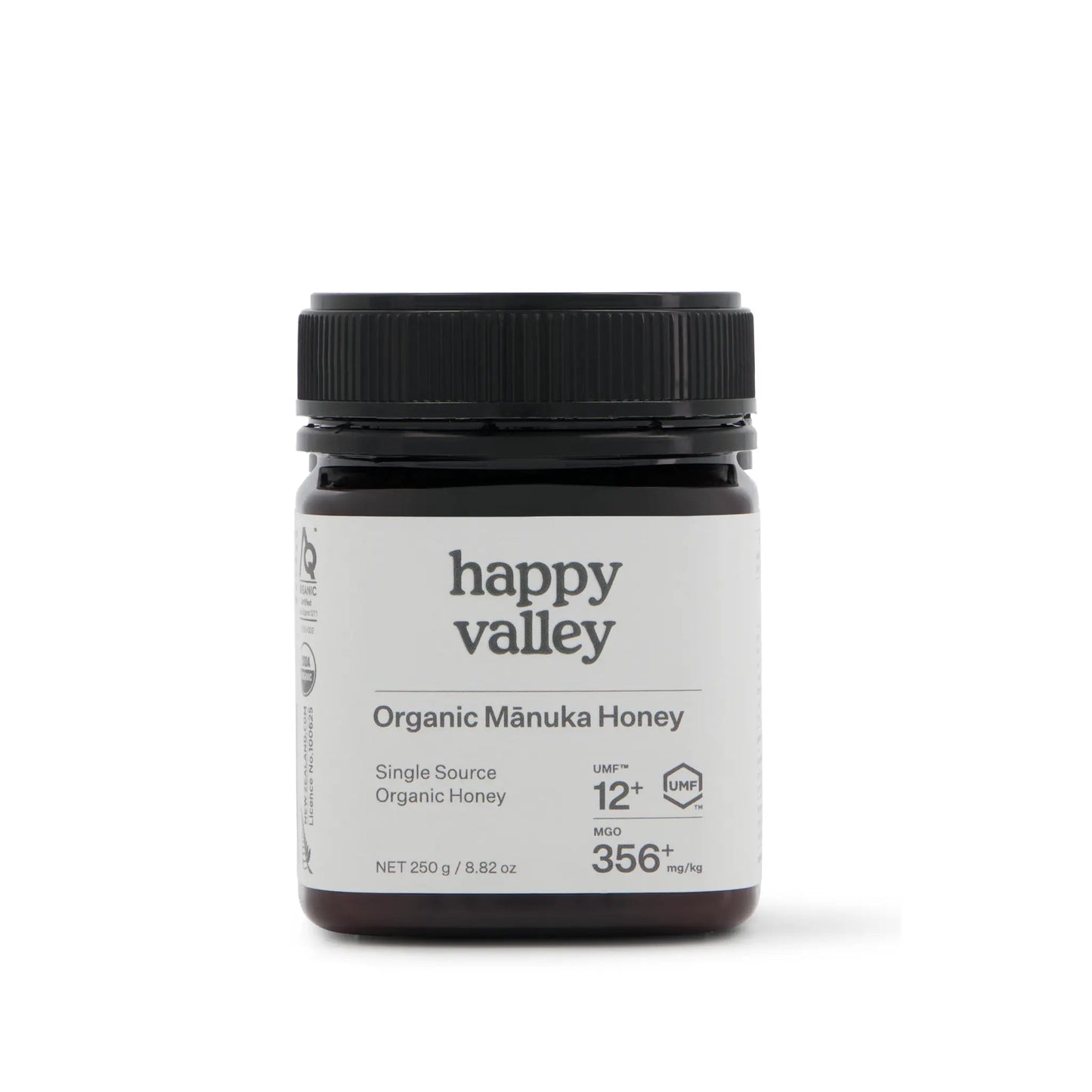 Organic Manuka Honey UMF® 12+ jar from Happy Valley Honey, showcasing golden, thick honey with a white label and wooden honey dipper
