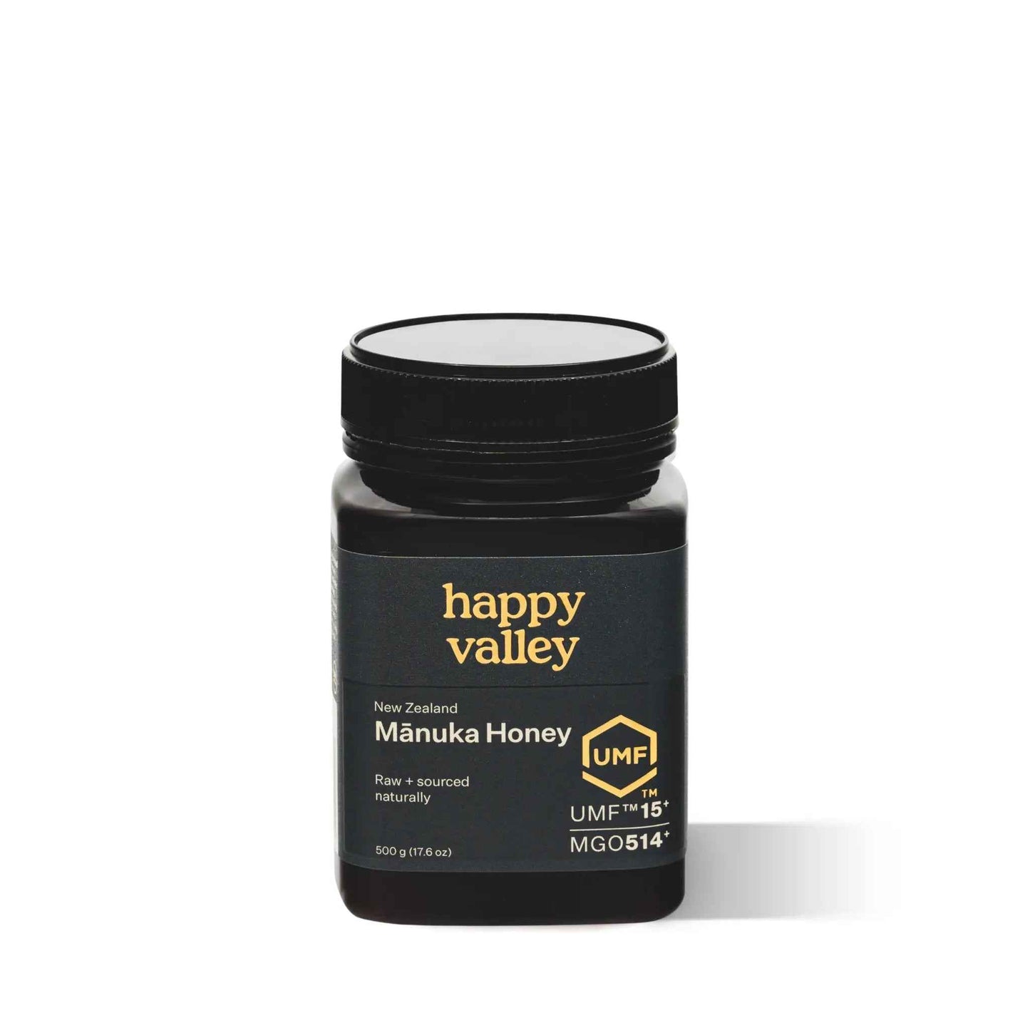 Jar of Happy Valley Honey Manuka Honey UMF® 15+ with golden honey inside on a wooden surface