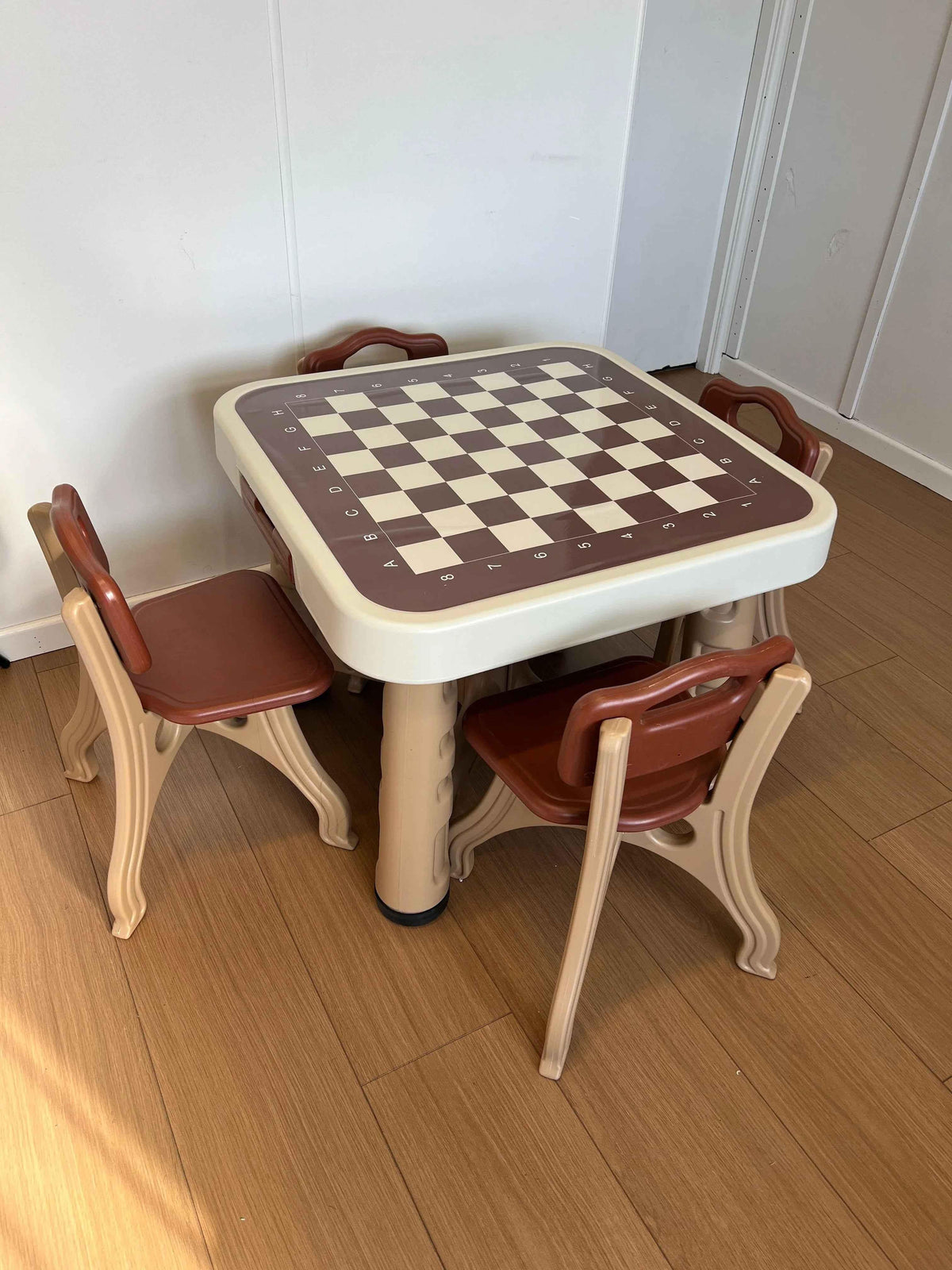 Kids’ play and activity table set with four chairs, game board, and storage compartments, designed for toddlers by Baby Way NZ.