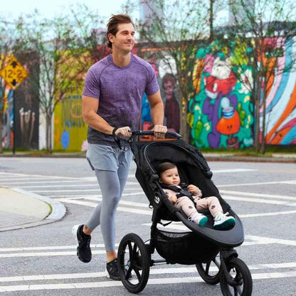 Baby Jogger Summit X3 jogging stroller in midnight black, featuring sturdy wheels and adjustable canopy for active outdoor walks.