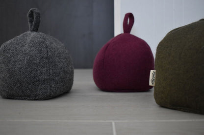 Felted New Zealand wool door stop by Do Not Disturb Sleep Company, showcasing a soft, handcrafted door accessory on a wooden floor.