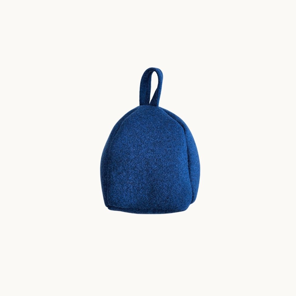 Felted New Zealand wool door stop by Do Not Disturb Sleep Company, brown and textured to hold doors open securely.