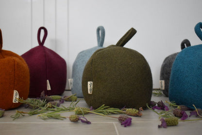 Felted New Zealand wool door stop by Do Not Disturb Sleep Company, soft textured and shaped to hold doors open securely.