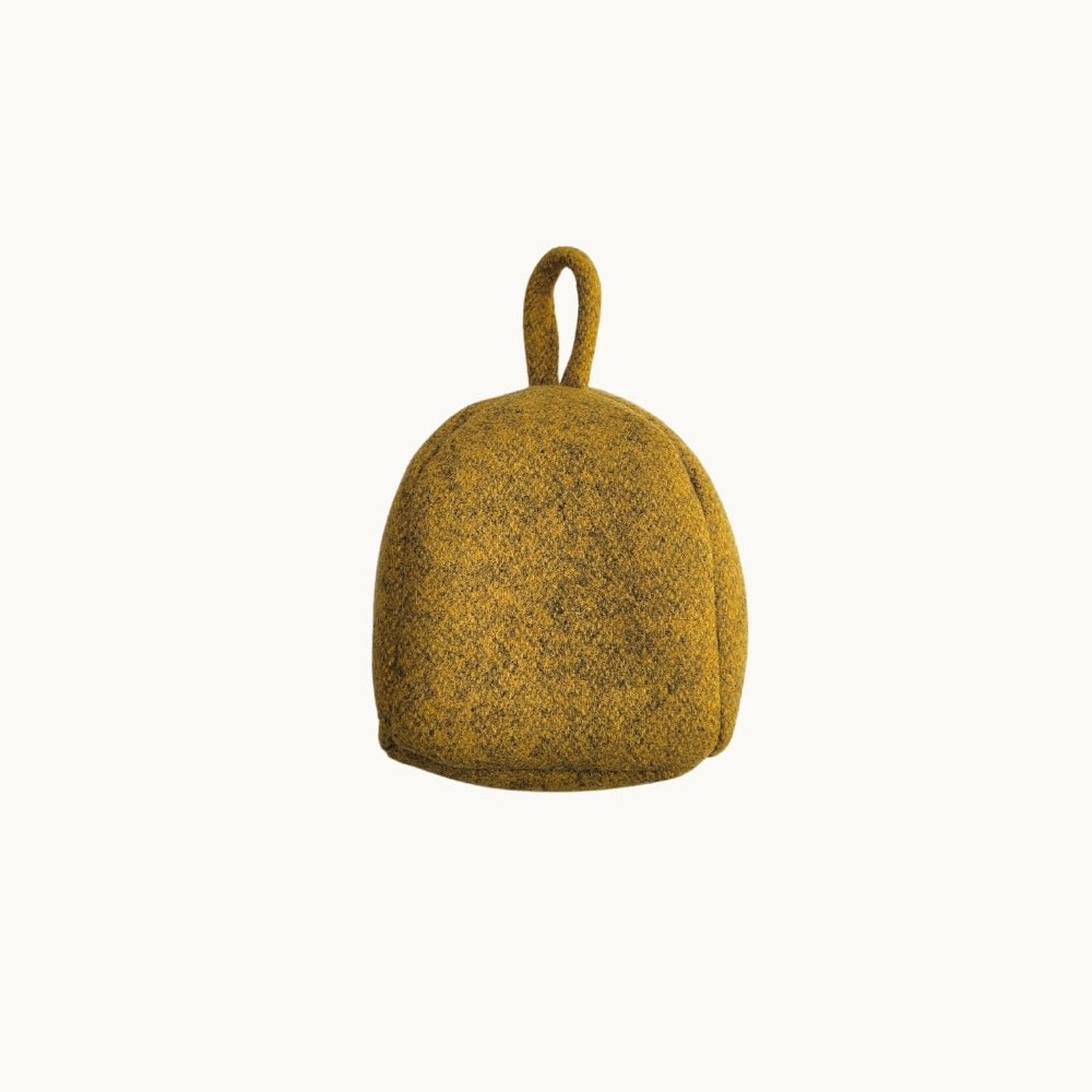 Felted New Zealand wool door stop from Do Not Disturb Sleep Company, plush and colorful with a cylindrical shape.