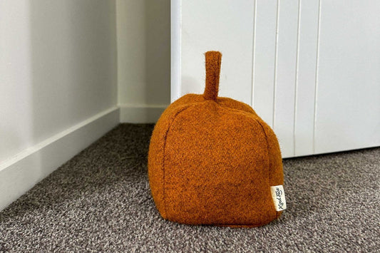 Felted NZ wool door stop by Do Not Disturb Sleep Company, showcasing a soft, handcrafted door accessory for preventing door movement.