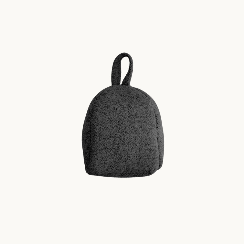 Felted NZ wool door stop from Do Not Disturb Sleep Company, soft and textured with a rounded shape for door stability.