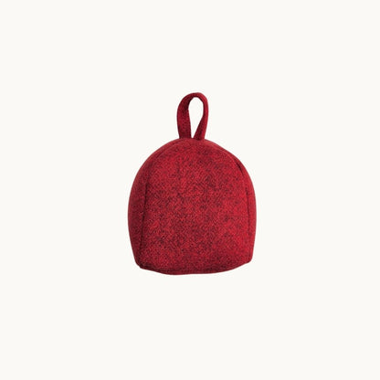 Felted New Zealand wool door stop from Do Not Disturb Sleep Company, soft textured and shaped to hold doors open securely.