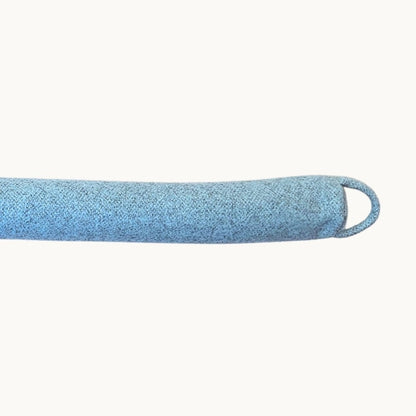 Felted New Zealand wool draught stopper from Do Not Disturb Sleep Company blocking a doorway to prevent drafts.