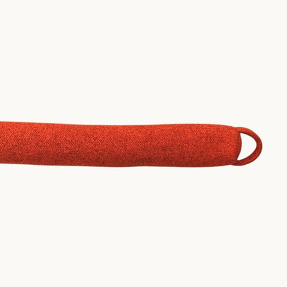 Felted NZ wool draught stopper from Do Not Disturb Sleep Company blocking a door gap to prevent drafts and heat loss.