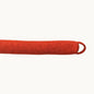 Felted NZ wool draught stopper from Do Not Disturb Sleep Company blocking a door gap to prevent drafts and heat loss.