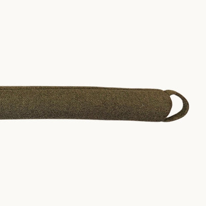 Felted NZ wool draught stopper by Do Not Disturb Sleep Company blocking a door or window to prevent drafts.