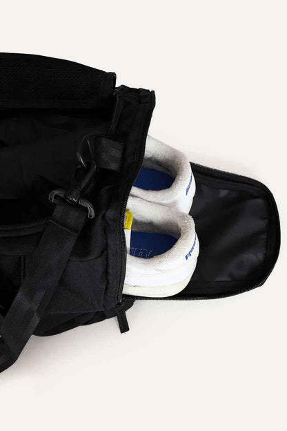 Black Fuaark Nz duffle bag with sturdy handles and spacious interior, perfect for stylish travel and weekend trips.
