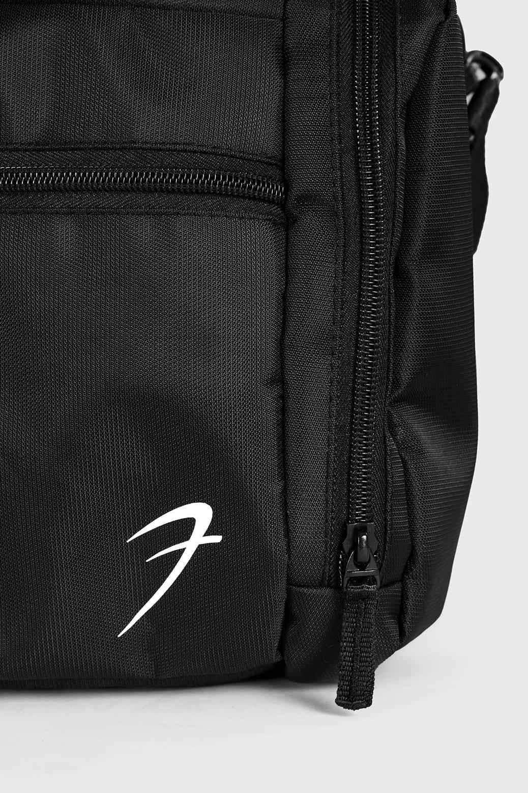 Black Fuaark Nz Elite Duffle Bag with sturdy handles and spacious main compartment for travel and gym use.