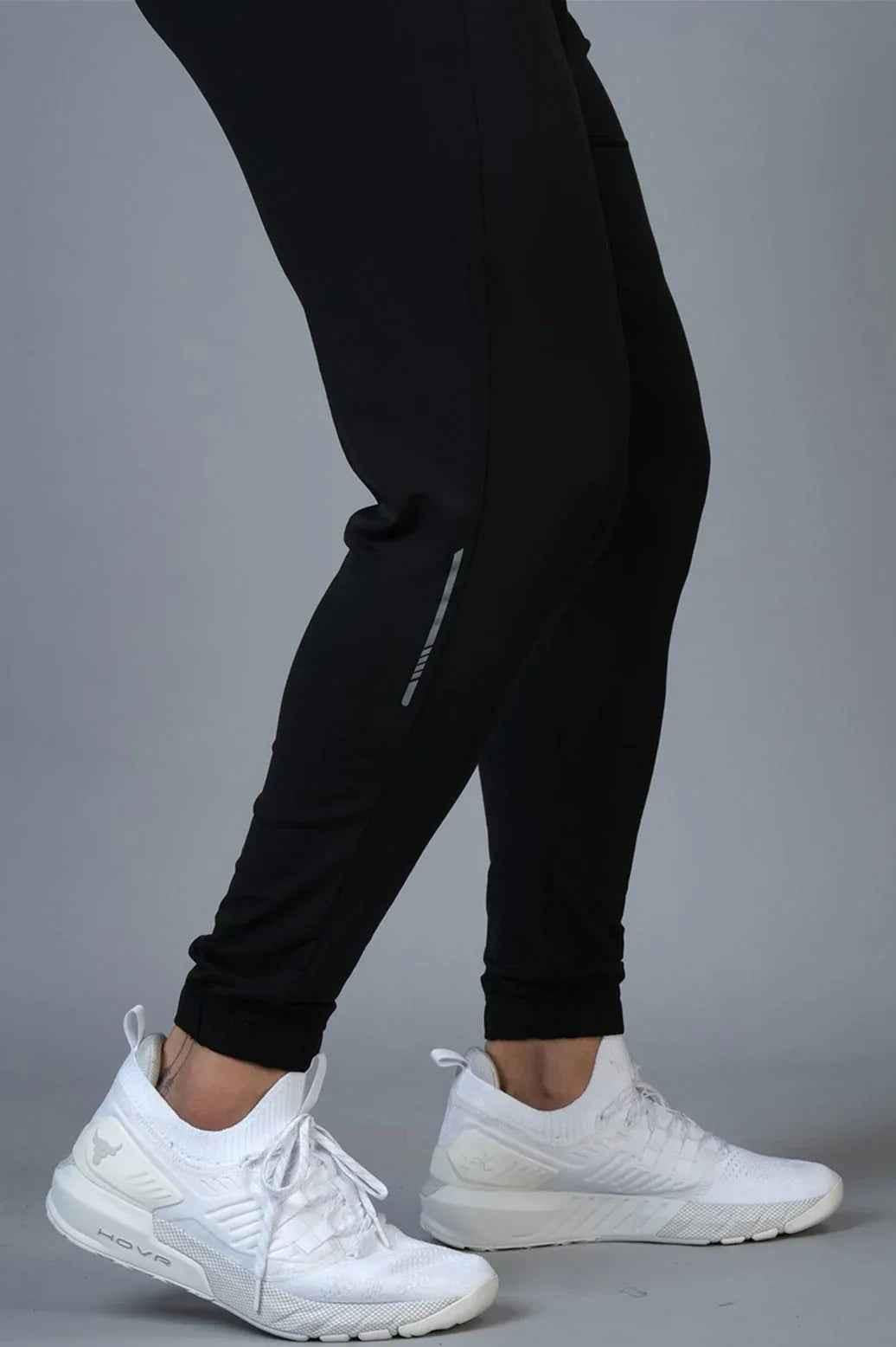 Black nylon joggers from Fuaark Nz with a relaxed fit, featuring an elastic waistband and tapered leg design.