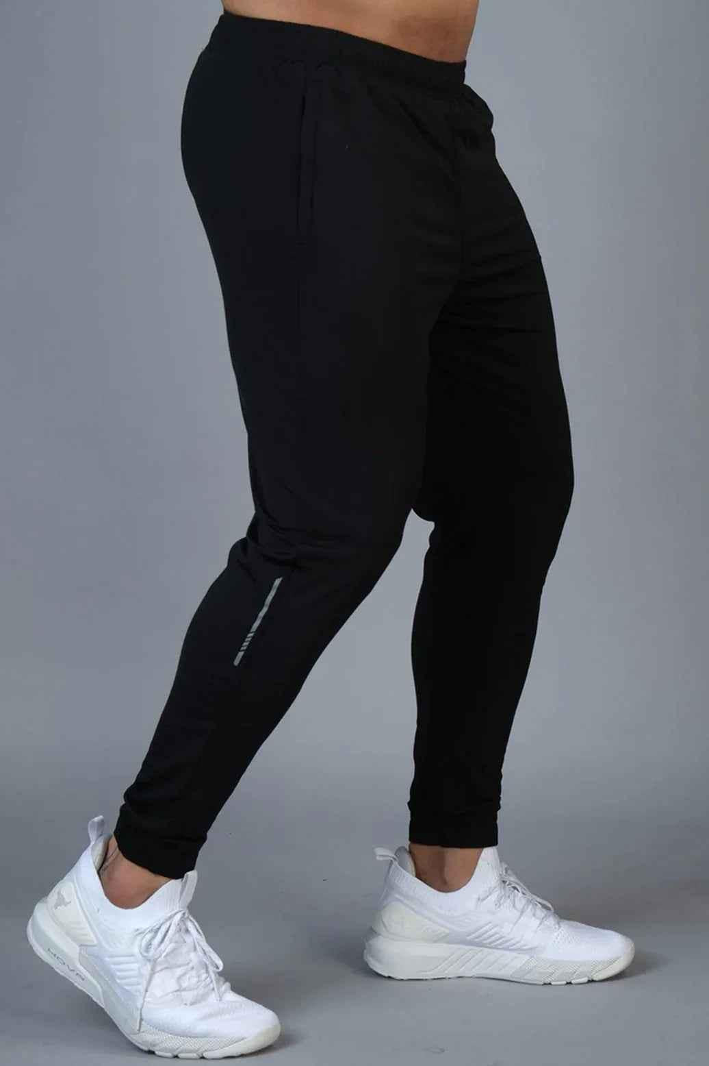 Black nylon joggers by Fuaark Nz with a relaxed fit, featuring an elastic waistband and side pockets in a casual style.