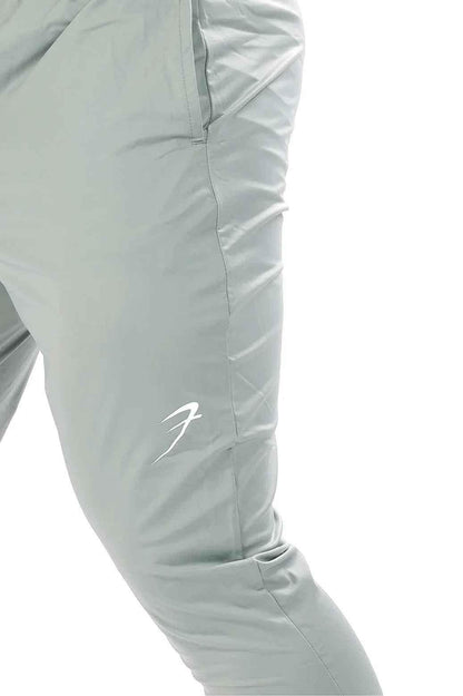 Light grey Nylon Supreme Fuaark Nz track showing the sleek, lightweight fabric and detailed stitching.