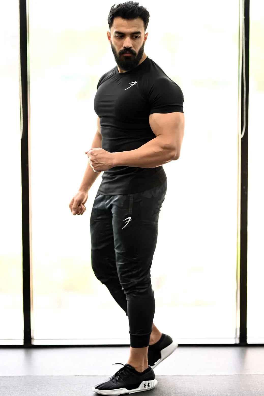 Black Fuaark Nz performance T-shirt, made of breathable fabric, featuring a sleek design and athletic fit.